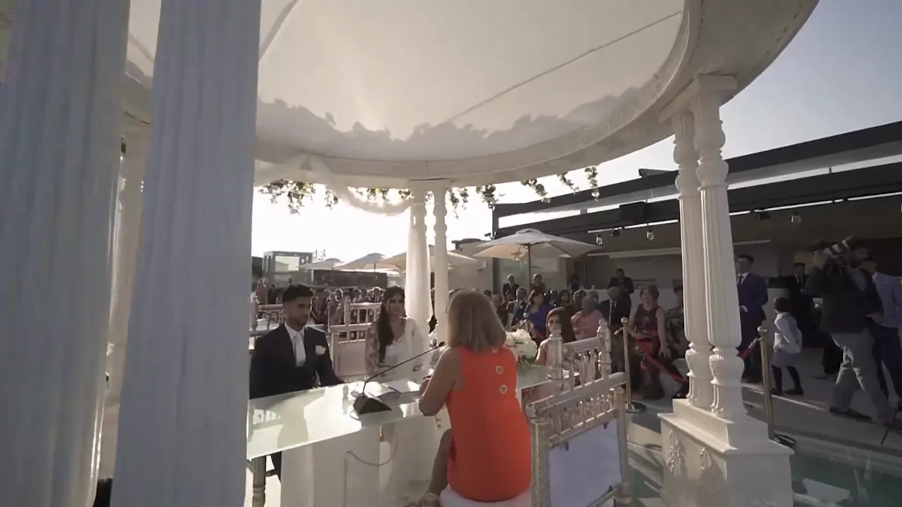 Civil ceremony under a white pavilion with guests watching at SUD Lisboa, wedding film by VIP Weddings Films